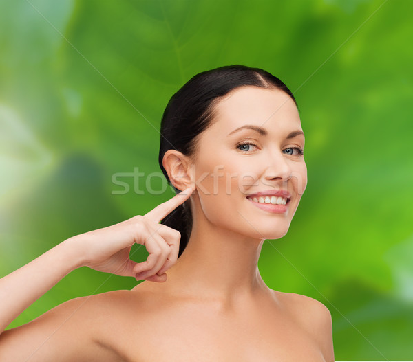 young calm woman pointing to her ear Stock photo © dolgachov