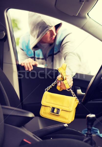 thief stealing bag from the car Stock photo © dolgachov