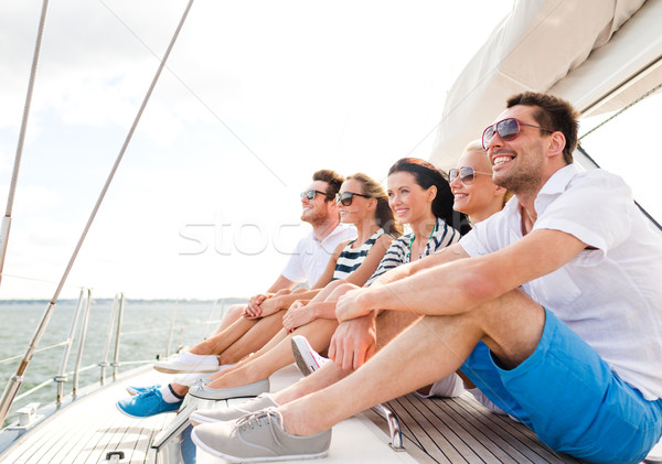 smiling friends sitting on yacht deck Stock photo © dolgachov