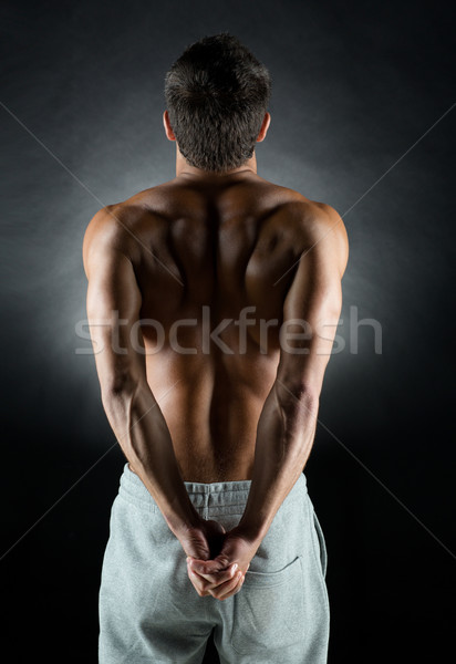 young male bodybuilder from back Stock photo © dolgachov