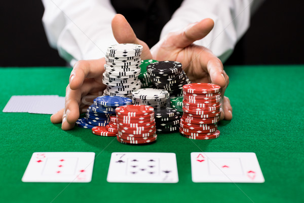 poker player with cards and chips at casino Stock photo © dolgachov