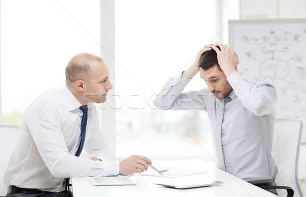 two serious businessmen with tablet pc in office Stock photo © dolgachov