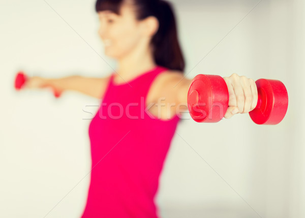 sporty woman hands with light red dumbbells Stock photo © dolgachov