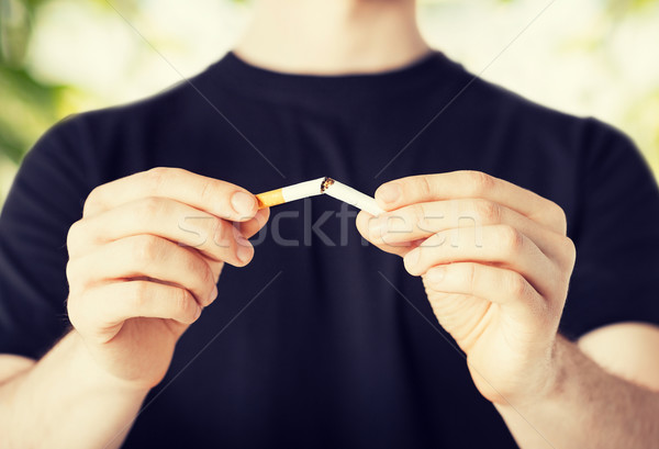 man breaking the cigarette with hands Stock photo © dolgachov