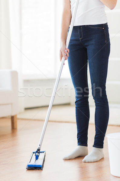 close up of woman with mop cleaning floor at home Stock photo © dolgachov
