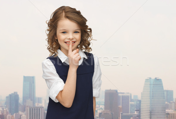 Stock photo: happy girl showing hush gesture