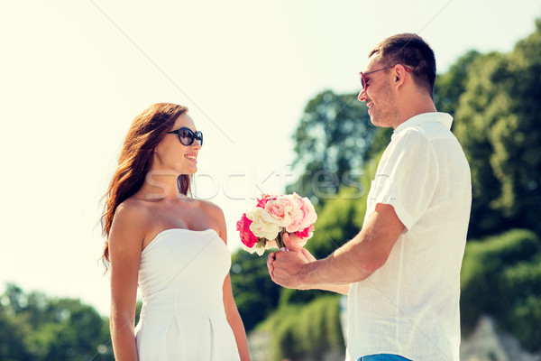 smiling couple in city Stock photo © dolgachov