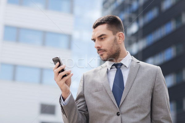 serious businessman with smartphone outdoors Stock photo © dolgachov