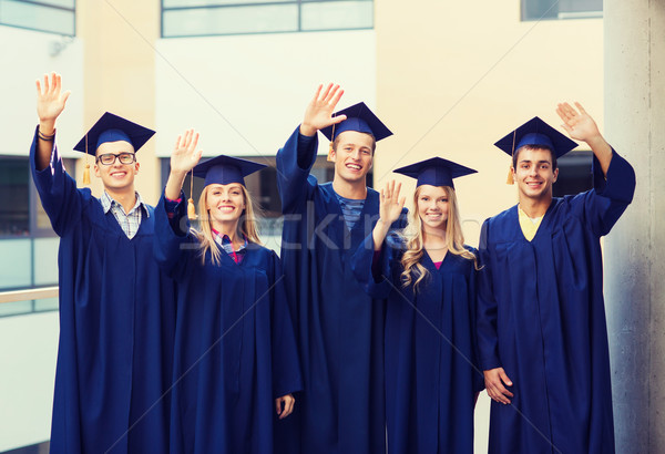 group of smiling students in mortarboards Stock photo © dolgachov