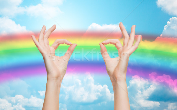 hands showing ok sign over rainbow background Stock photo © dolgachov