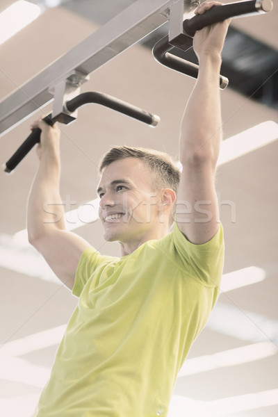 smiling man exercising in gym Stock photo © dolgachov