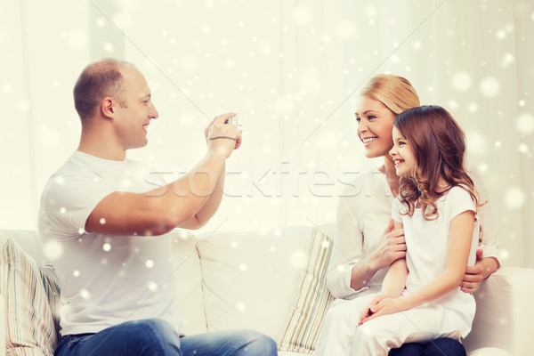 happy family with camera taking picture at home Stock photo © dolgachov