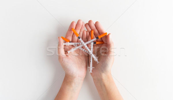 close up of woman hands holding syringes Stock photo © dolgachov