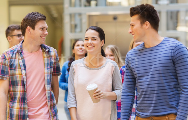 group of smiling students with paper coffee cups Stock photo © dolgachov
