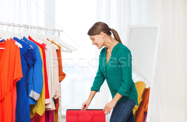 happy woman with shopping bags and clothes at home Stock photo © dolgachov