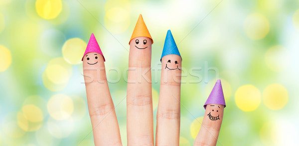Közelkép kéz négy ujjak buli sapkák Stock fotó © dolgachov