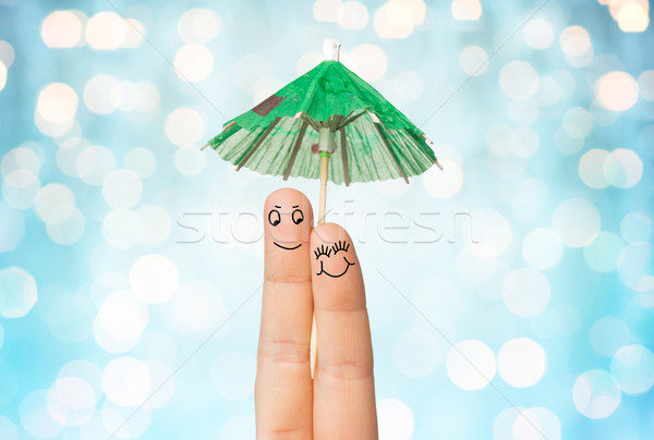 close up of two fingers with cocktail umbrella Stock photo © dolgachov