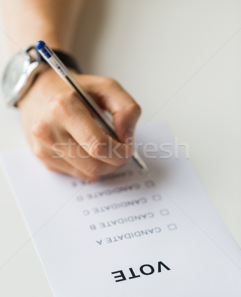 close up of hands with vote or ballot on election Stock photo © dolgachov