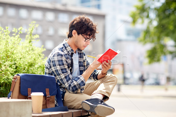 Stock photo: man with notebook or diary writing on city street