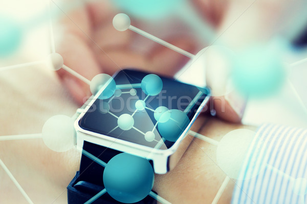 close up of hands with molecules on smartwatch Stock photo © dolgachov