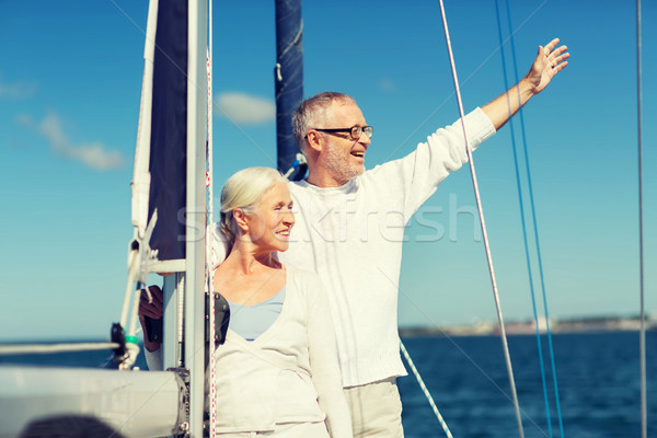 Stock photo: senior couple hugging on sail boat or yacht in sea