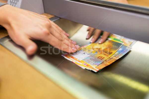 clerk giving cash money to customer at bank office Stock photo © dolgachov