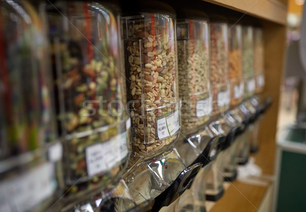 row of jars with nuts and seeds at grocery store Stock photo © dolgachov
