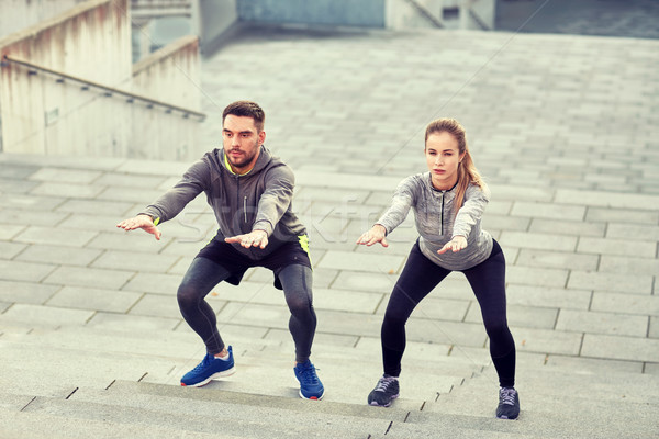 couple doing squats and exercising outdoors Stock photo © dolgachov