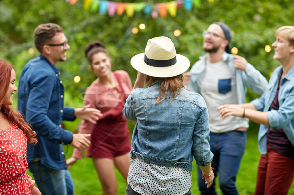 happy friends dancing at summer party in garden stock photo © Syda ...