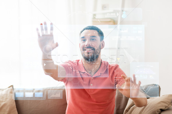 happy man touching virtual screen at home Stock photo © dolgachov