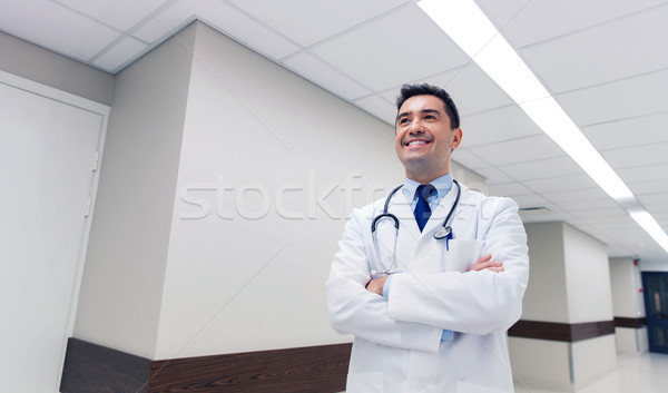 smiling doctor in white coat at hospital Stock photo © dolgachov