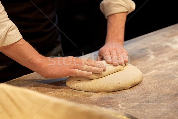 chef or baker cooking dough at bakery Stock photo © dolgachov