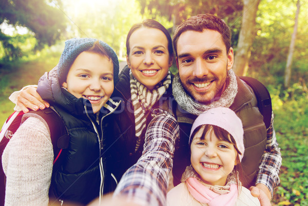 family with backpacks taking selfie and hiking Stock photo © dolgachov