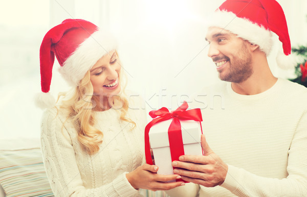 Stock photo: happy couple at home with christmas gift box