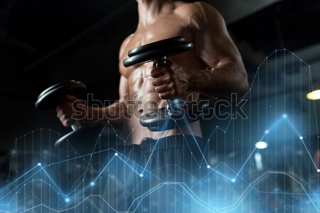 close up of man with dumbbells exercising in gym Stock photo © dolgachov