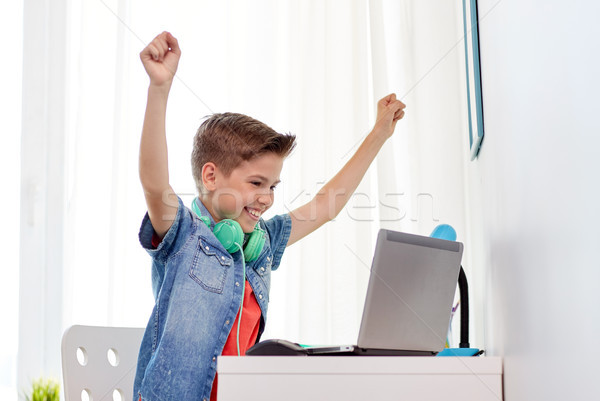 boy with headphones playing video game on laptop Stock photo © dolgachov