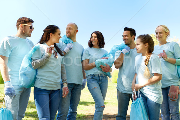 group of volunteers with garbage bags in park Stock photo © dolgachov