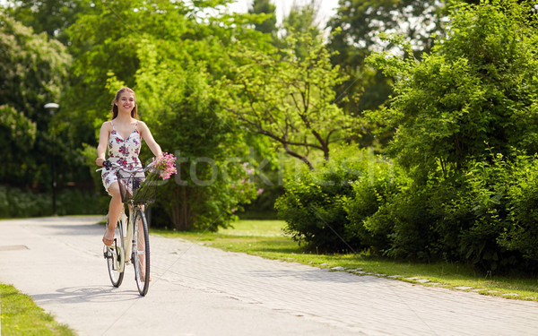 Stock photo: happy woman riding fixie bicycle in summer park
