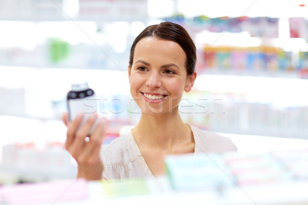 female customer choosing drugs at pharmacy Stock photo © dolgachov
