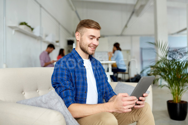 man with tablet pc working at office Stock photo © dolgachov