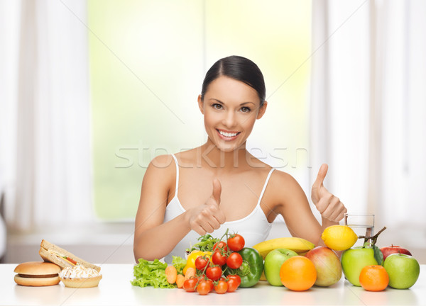 woman with fruits rejecting junk food Stock photo © dolgachov