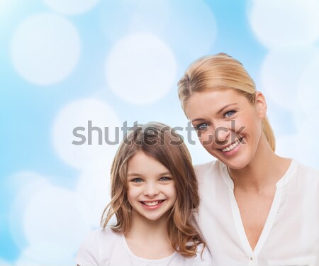smiling mother and little girl at home Stock photo © dolgachov