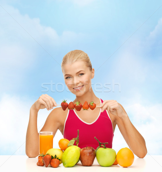 smiling young woman with organic food on the table Stock photo © dolgachov