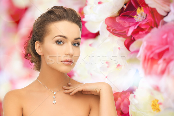 woman wearing shiny diamond pendant Stock photo © dolgachov