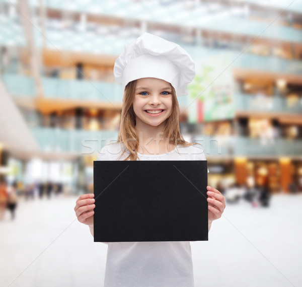 little cook or baker with blank black paper Stock photo © dolgachov