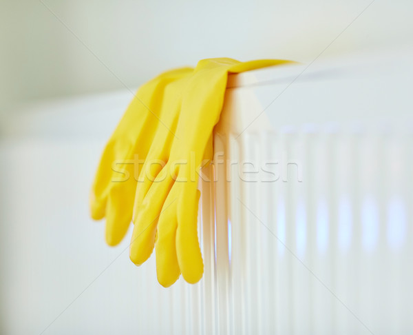 close up of rubber gloves hanging on heater Stock photo © dolgachov