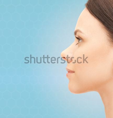 beautiful young woman face over violet background Stock photo © dolgachov