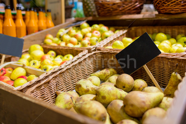 fruits in baskets with nameplates at food market Stock photo © dolgachov