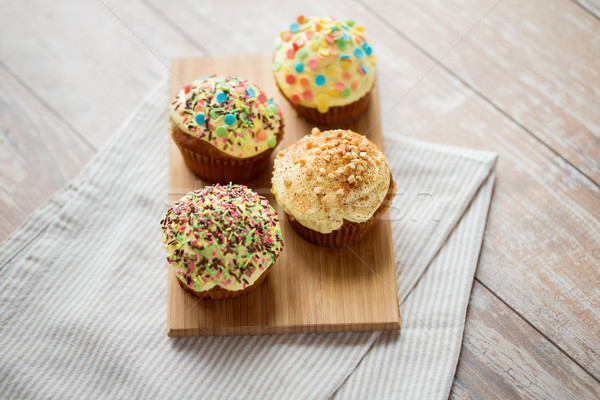 close up of glazed cupcakes or muffins on table Stock photo © dolgachov