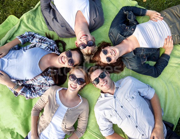 group of students or teenagers lying in circle Stock photo © dolgachov